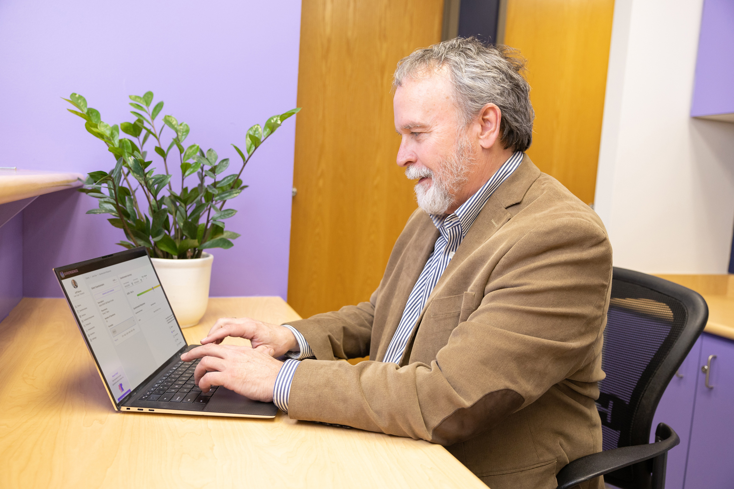 Therapist Reviewing Questionnaire Results on Laptop