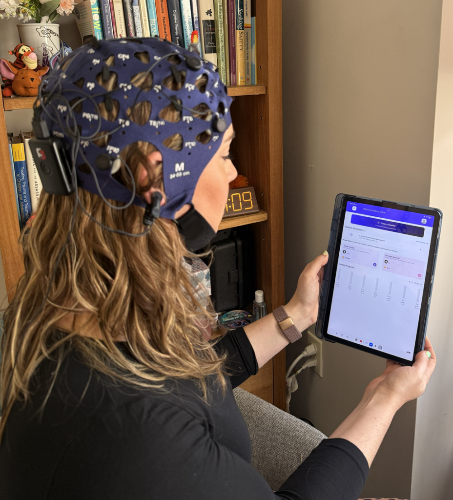Leanne Wearing Synchroni Device Viewing Dive Mobile App