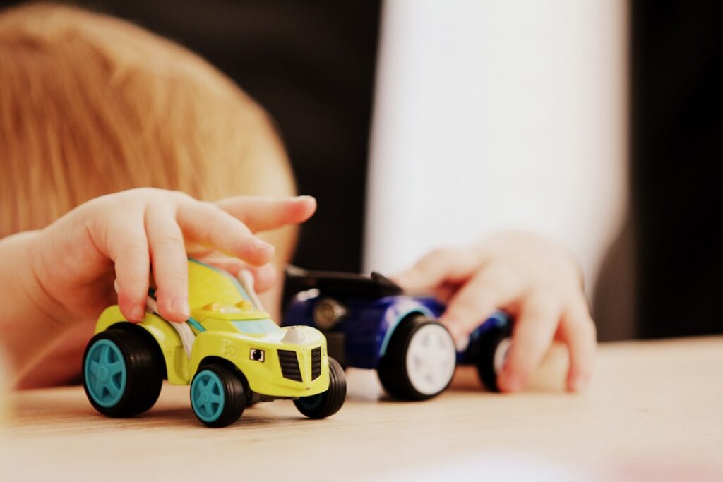A child playing happily with colorful toy cars, fully engaged